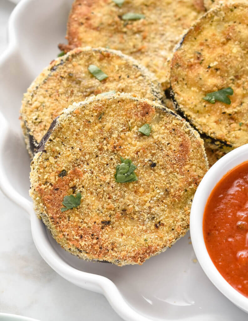 Close up of baked and breaded eggplant slices..