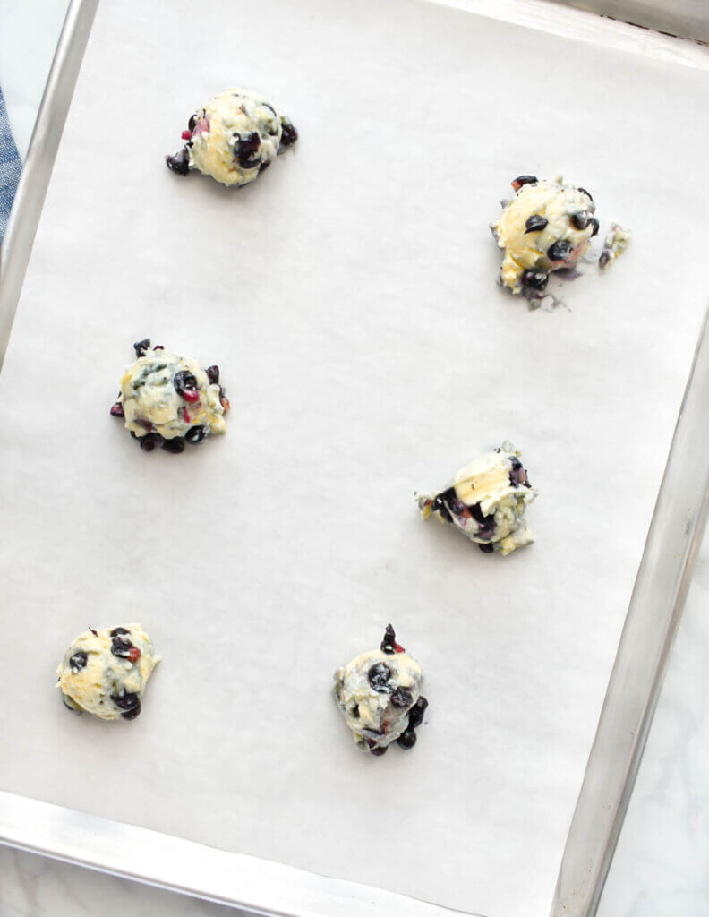 6 mounds of Blueberry Muffin Top batter scooped onto a baking sheet lined with parchment paper.