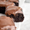 Slices of Chocolate Zucchini Cake topped with chocolate frosting.