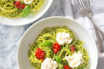 Plates of Pesto Pasta with Sundried Tomatoes and Burrata.