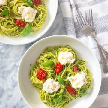 Plates of Pesto Pasta with Sundried Tomatoes and Burrata.
