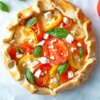 A Tomato and Feta Galette sprinkled with extra feta and fresh basil.