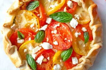 A Tomato and Feta Galette sprinkled with extra feta and fresh basil.