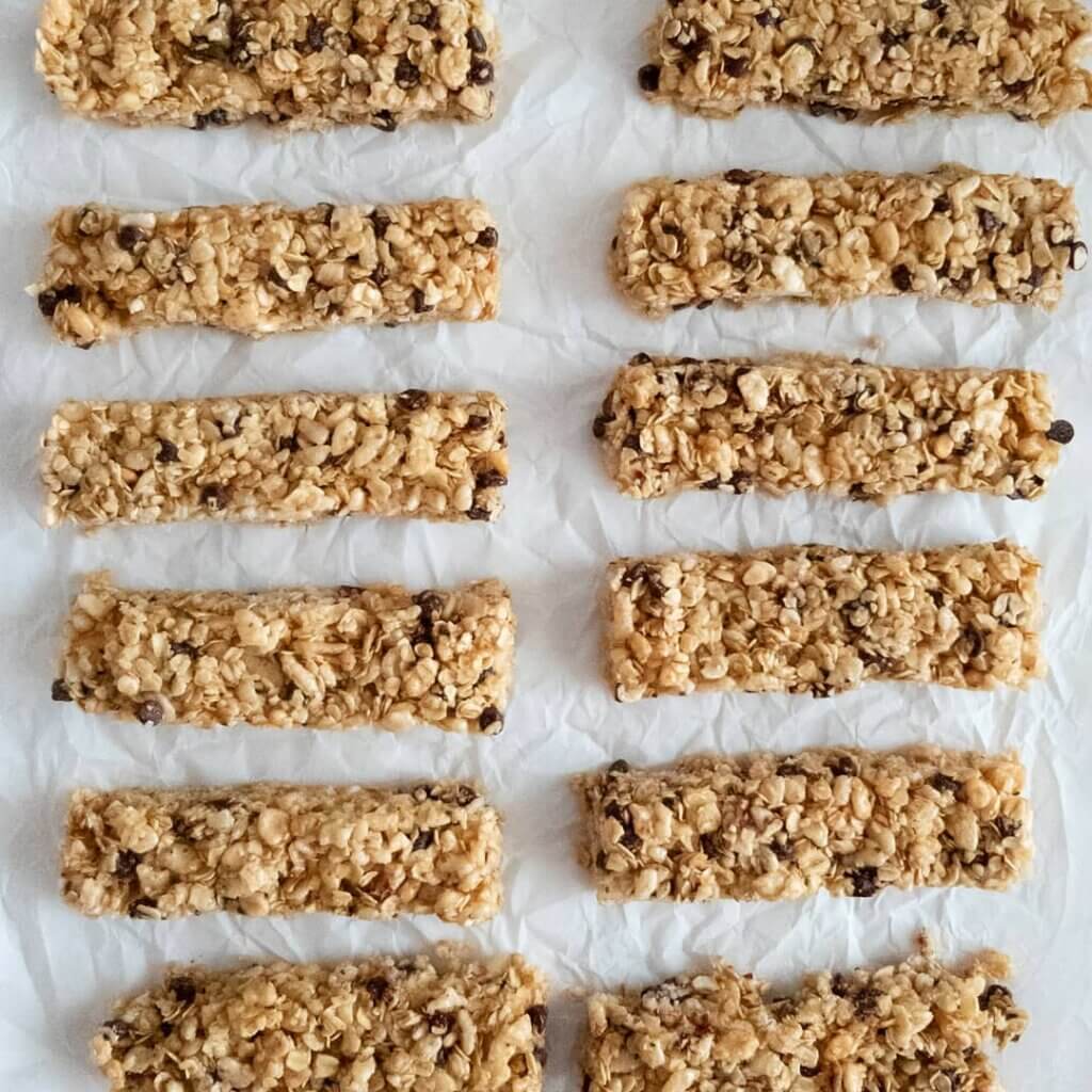 Sliced Chewy Chocolate Chip Granola Bars on parchment paper.