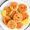Platter of Salmon Cakes served with lemon wedges.