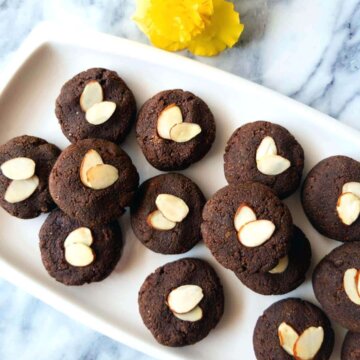 chocolate almond cookies topped with almond slices