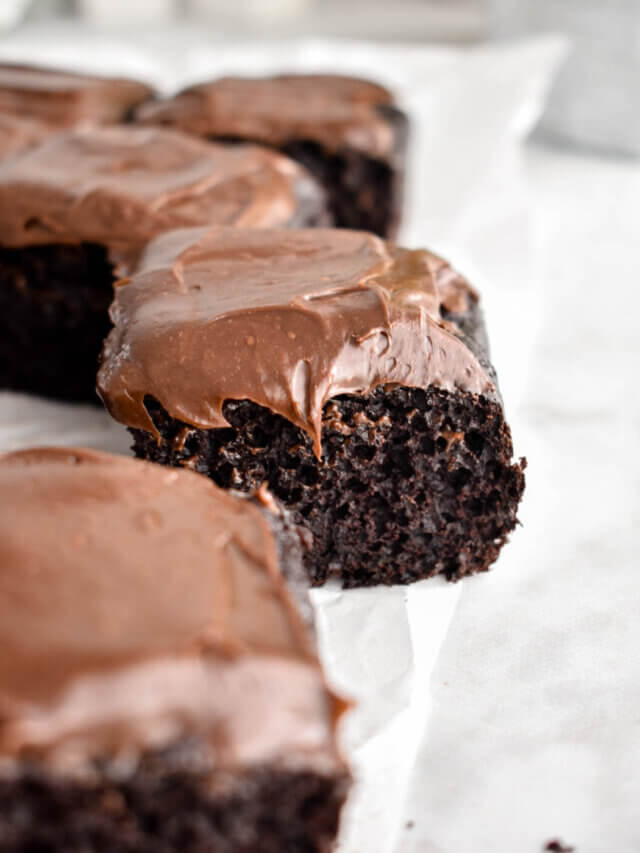 Slices of Chocolate Zucchini Cake topped with chocolate frosting.