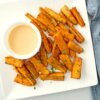 A square platter of Sweet Potato Wedges with Spicy Honey Mustard Dip.