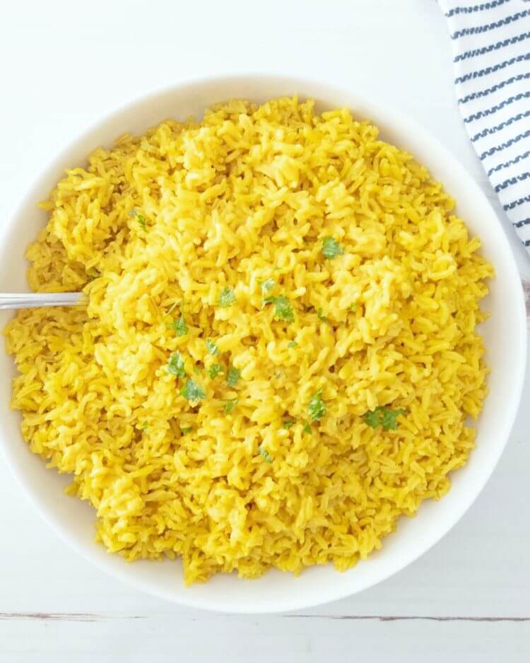 turmeric coconut rice topped with fresh cilantro