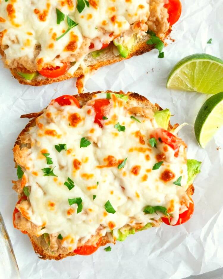 avocado tuna melt with lime slices on a baking sheet