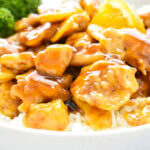 Close up of a plate of saucy Baked Orange Chicken.