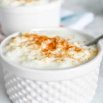 Rice Pudding (or rizogalo) in a ramekin and sprinkled with cinnamon.