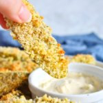 Oven Fried Pickle being dipped in a creamy ranch dip.