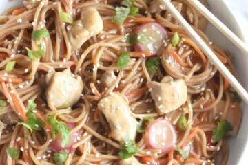 A bowl of Sweet Citrus Stir Fry noodles with pieces of chicken and veggies.