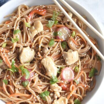 A bowl of Sweet Citrus Stir Fry noodles with pieces of chicken and veggies.