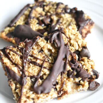 Slices of chocolate chip baked oatmeal drizzled with melted chocolate.