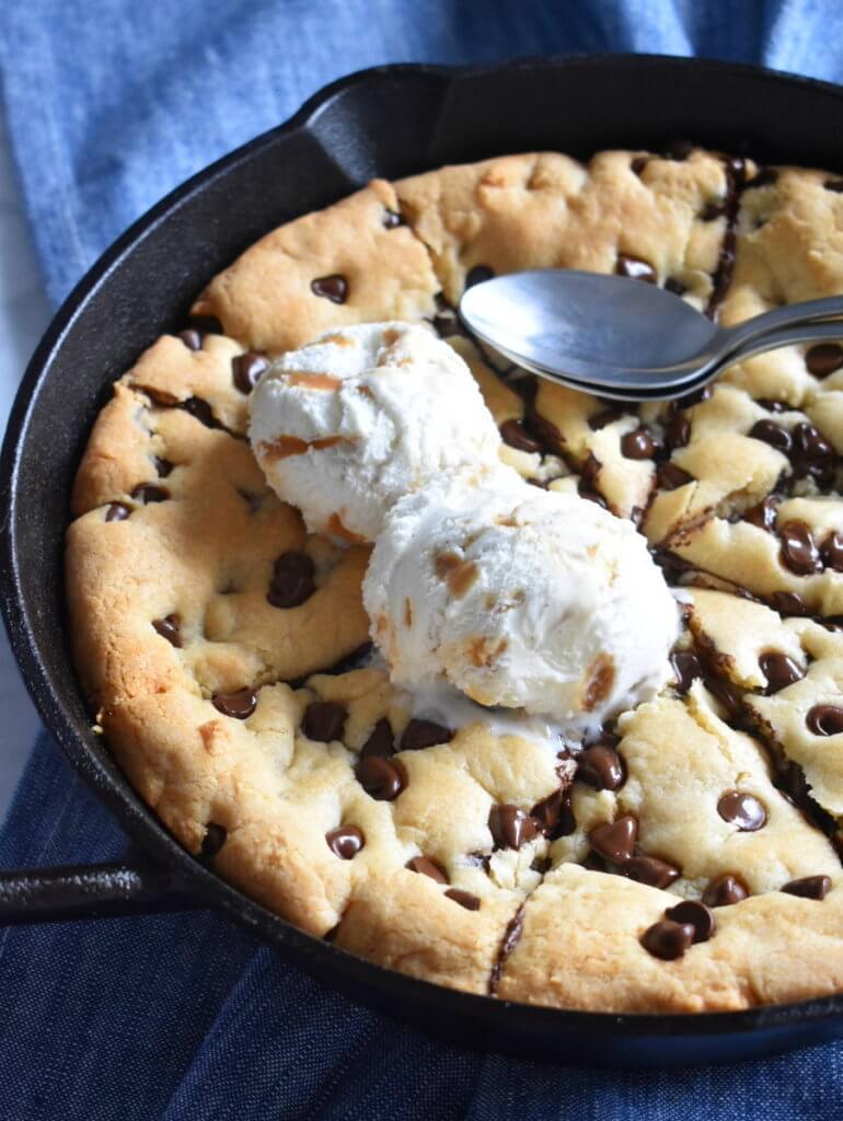 chocolate chip skillet cookie topped with ice cream.