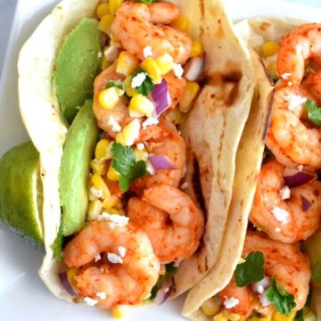 Chili Lime Shrimp Tacos with Mexican Street Corn Salsa and avocado on a platter.