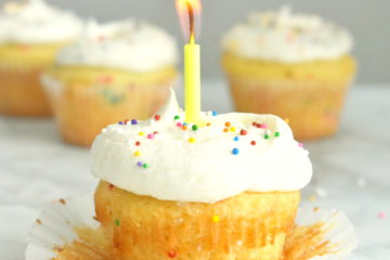 A Funfetti Cupcake with a birthday candle in it.