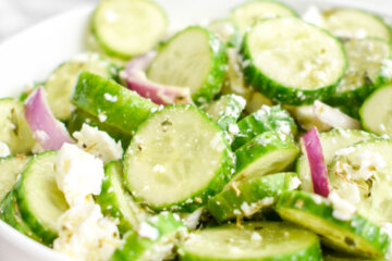 A bowl of Cucumber Feta Salad with red onions.