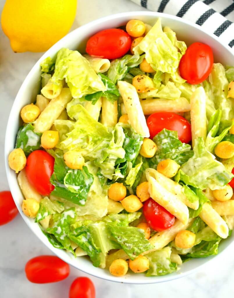 Bowl of Healthy Caesar Pasta Salad with cherry tomatoes.