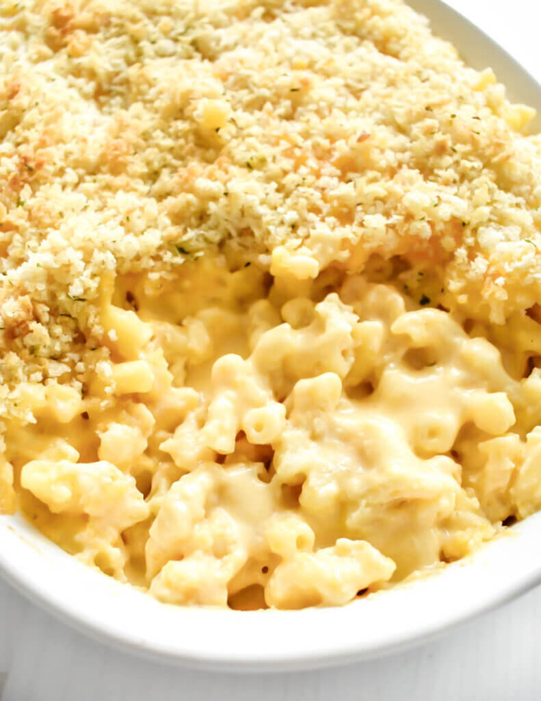 Baking dish of creamy macaroni and cheese with a toasted panko breadcrumb topping.