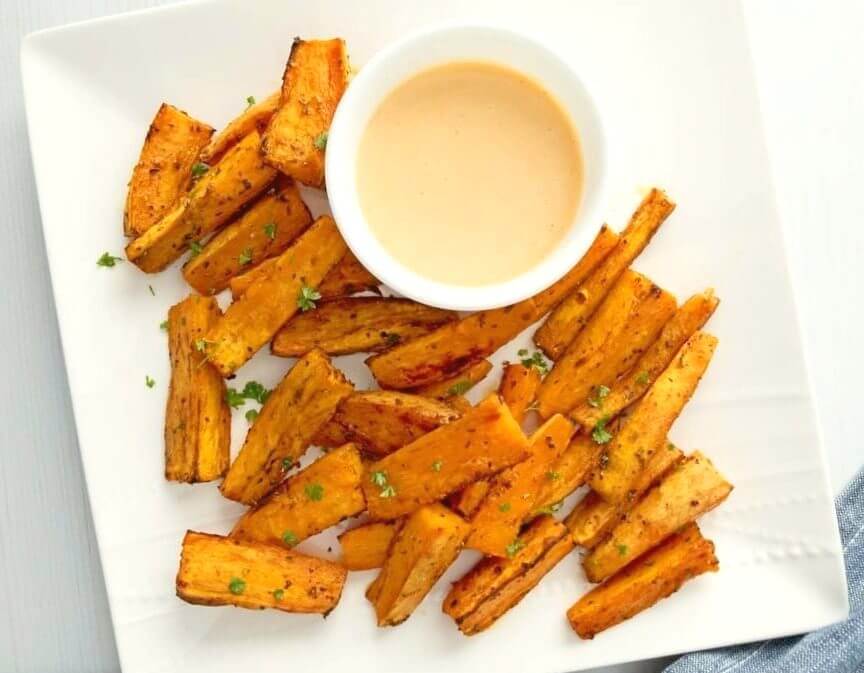 Close up of a platter of Sweet Potato Wedges with Spicy Honey Mustard Dip.