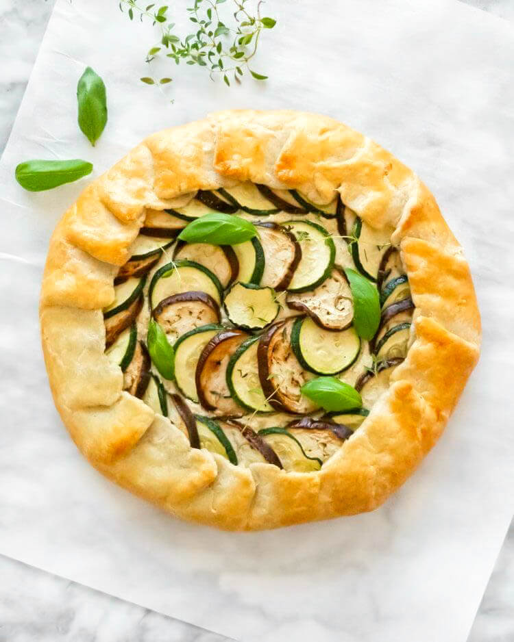 A Mediterranean Vegetable Galette made with zucchini and eggplant slices and fresh herbs.