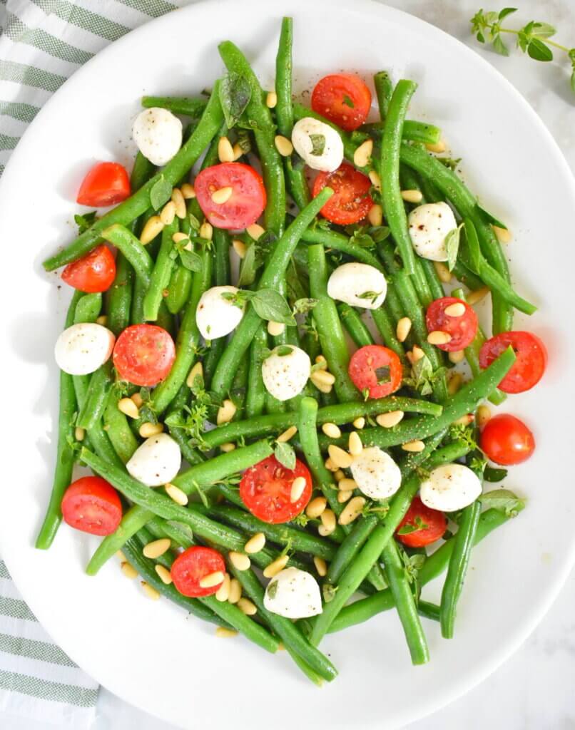 Green Bean Salad with Lemon Herb Vinaigrettem cherry tomatoes, pine nuts and mini mozzarella balls