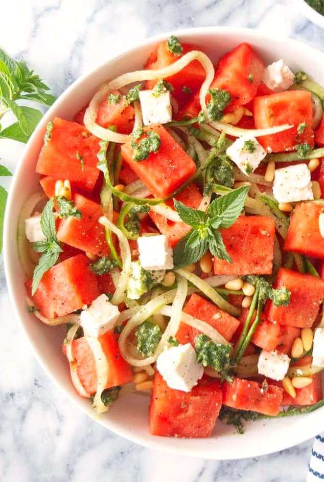 Closeup of a bowl of Watermelon and Cucumber Noodle Salad with Mint Pesto, Pine nuts and Feta.