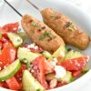 Plate with 2 Chicken Kofta Kebabs and a Greek salad.