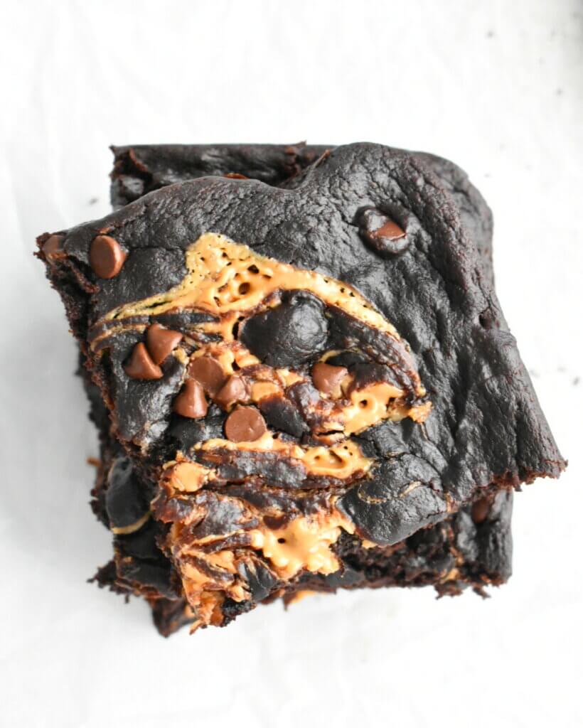 Vegan Sweet Potato Brownies with swirls of peanut butter and chocolate chips sprinkled overtop.