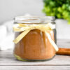 A jar of Homemade Pumpkin Pie Spice tied with a yellow ribbon.