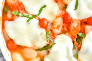 Closeup of a pan of Baked Gnocchi with melted mozzerella on top.
