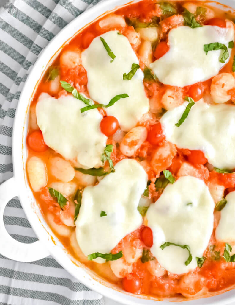 Baked Gnocchi in a rich tomato sauce with chopped cherry tomatoes, mozzerella and fresh basil.