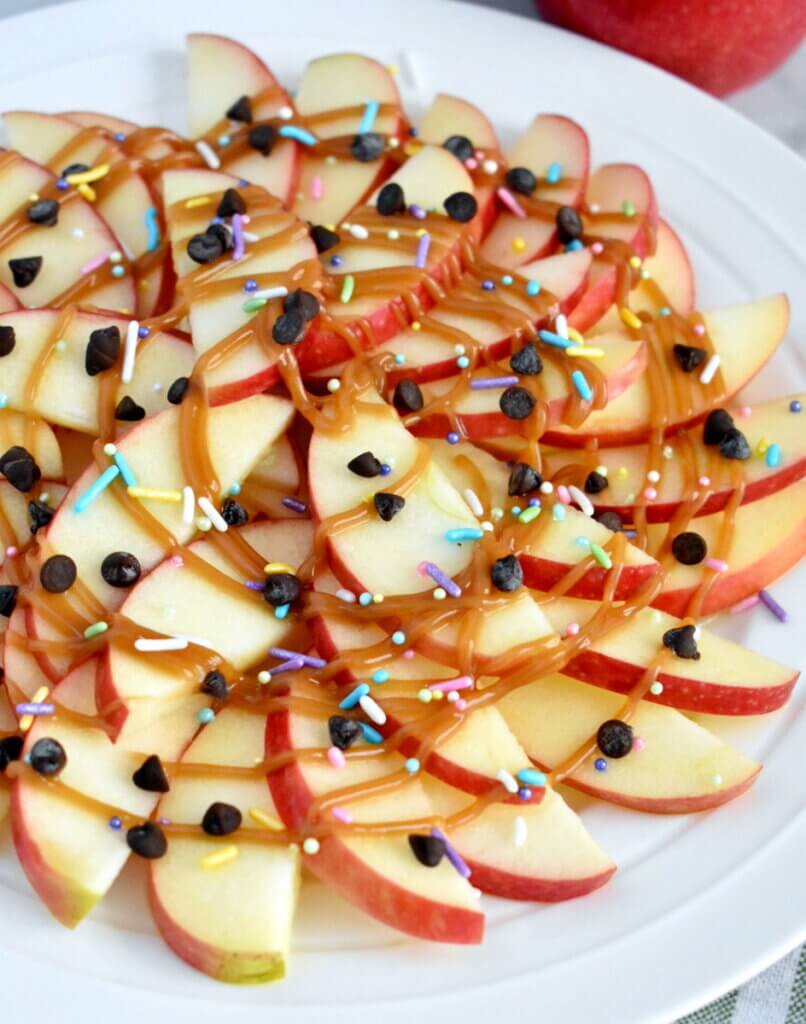 Platter of Apple Nachos with caramel, chocolate chips, and sprinkles.