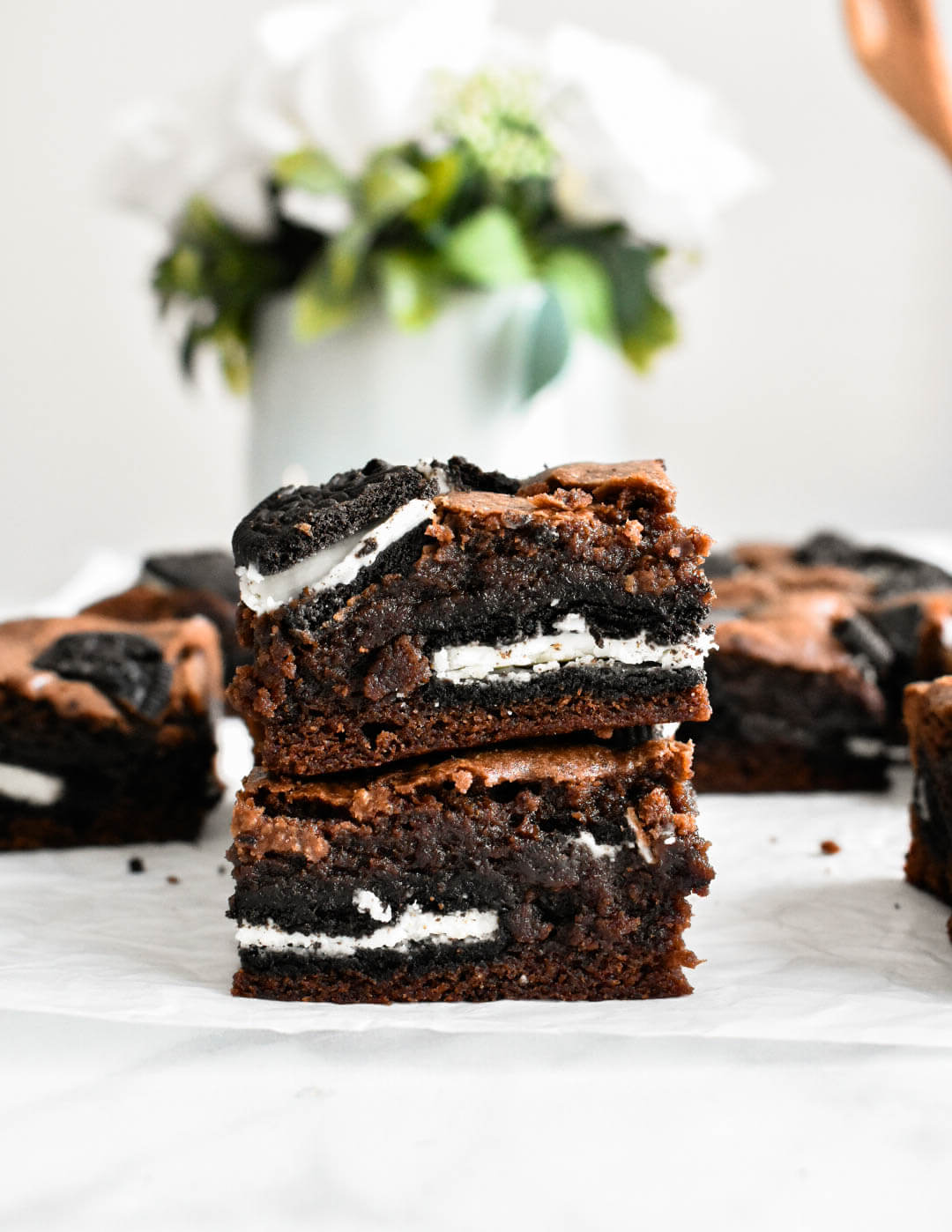 Two fudgy Oreo Brownies stacked on top of each other.