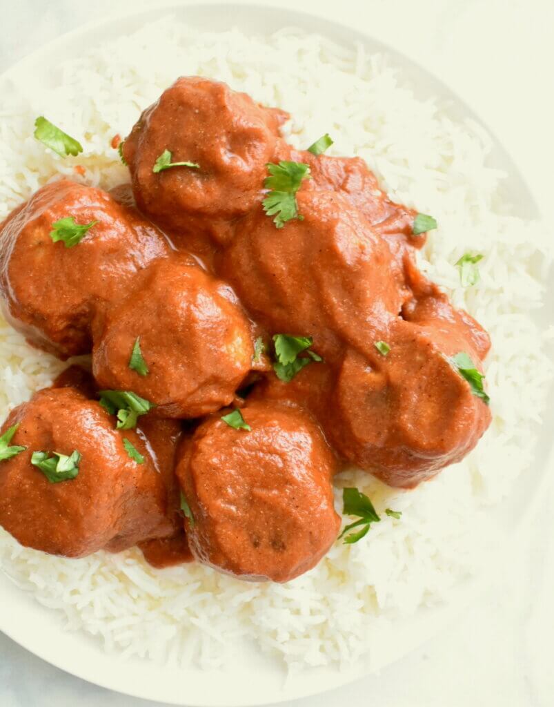 Plate of Butter Chicken Meatballs served over rice.