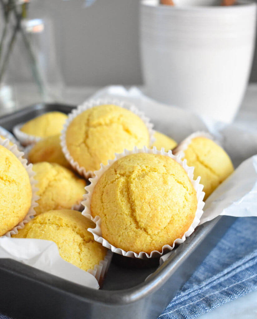 Corn Muffins in a baking pan on a kitchen counter.