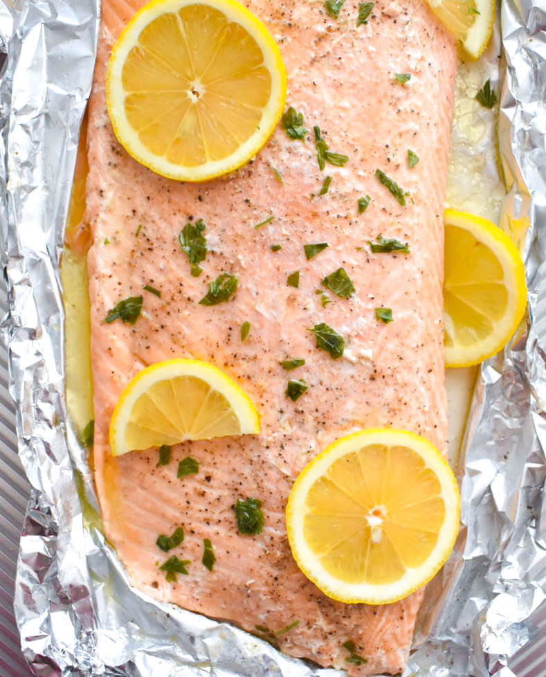 Baked Herb Butter Salmon topped with lemon slices in foil