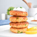 Stack of shrimp patties topped with sour cream