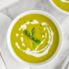 Bowl of Asparagus Soup drizzled with cream