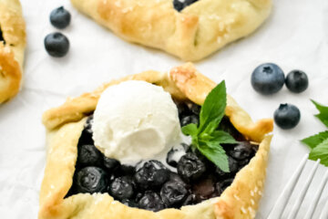 Mini Blueberry Galettes topped with an ice cream scoop and fresh mint.