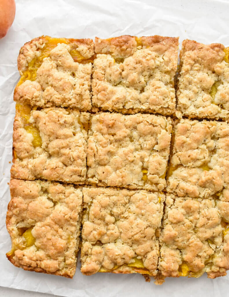 Healthy Peach Crumble Bars on parchment paper