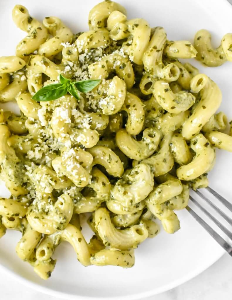 creamy pesto pasta topped with fresh basil