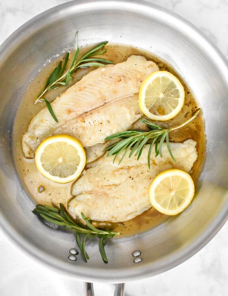pan of basa fish fillets in a brown butter sauce