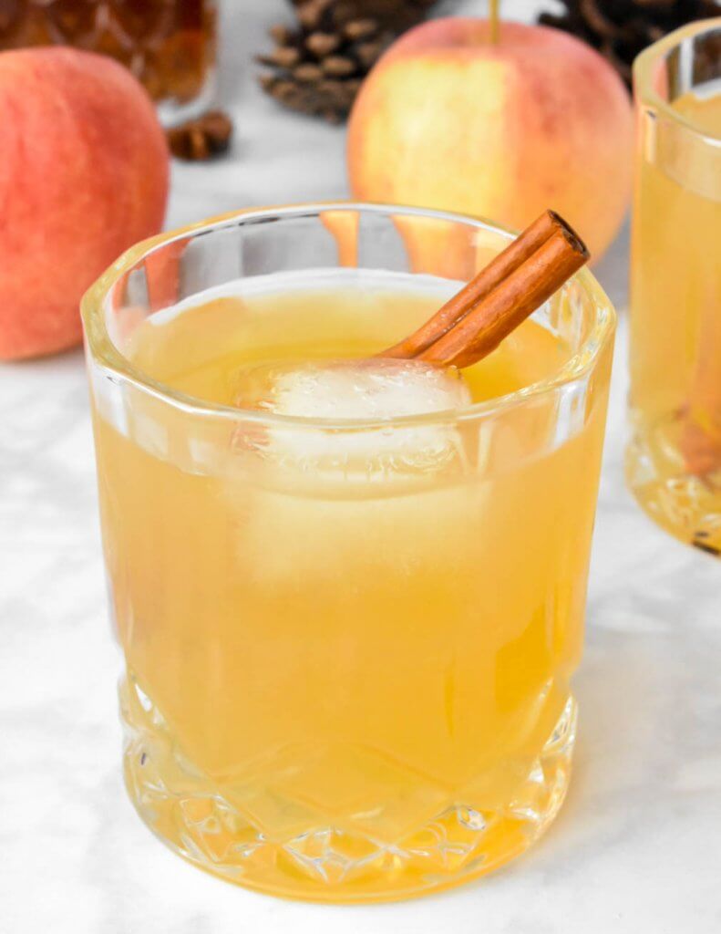 Top view of Apple Cider Whiskey Sour garnished with a cinnamon stick
