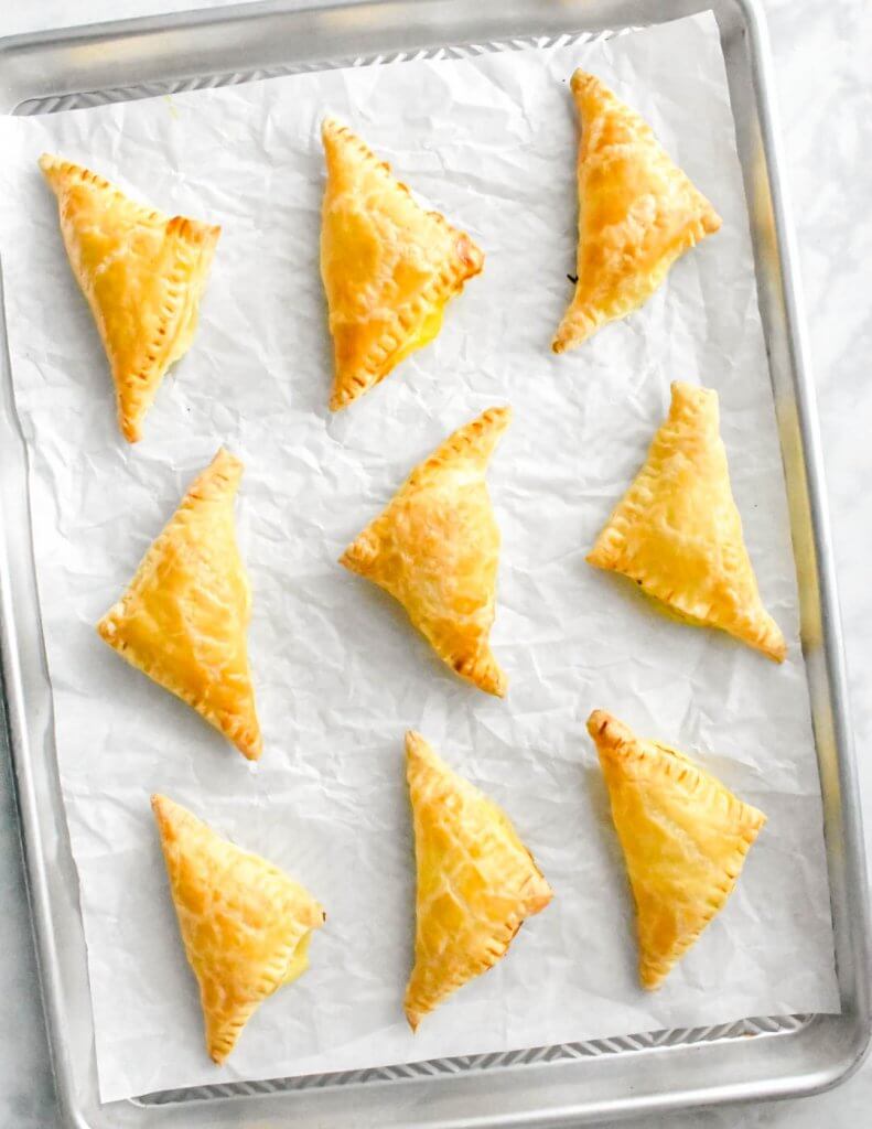 Tray of baked tiropita made with puff pastry