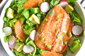Asian Salmon Salad bowl with radishes, orange and avocado