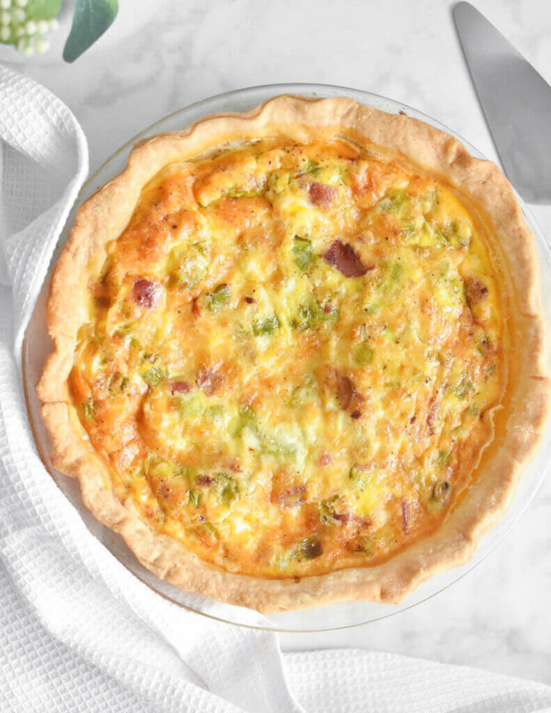 Bacon & Leek Quiche baked and ready to serve in a quiche pan